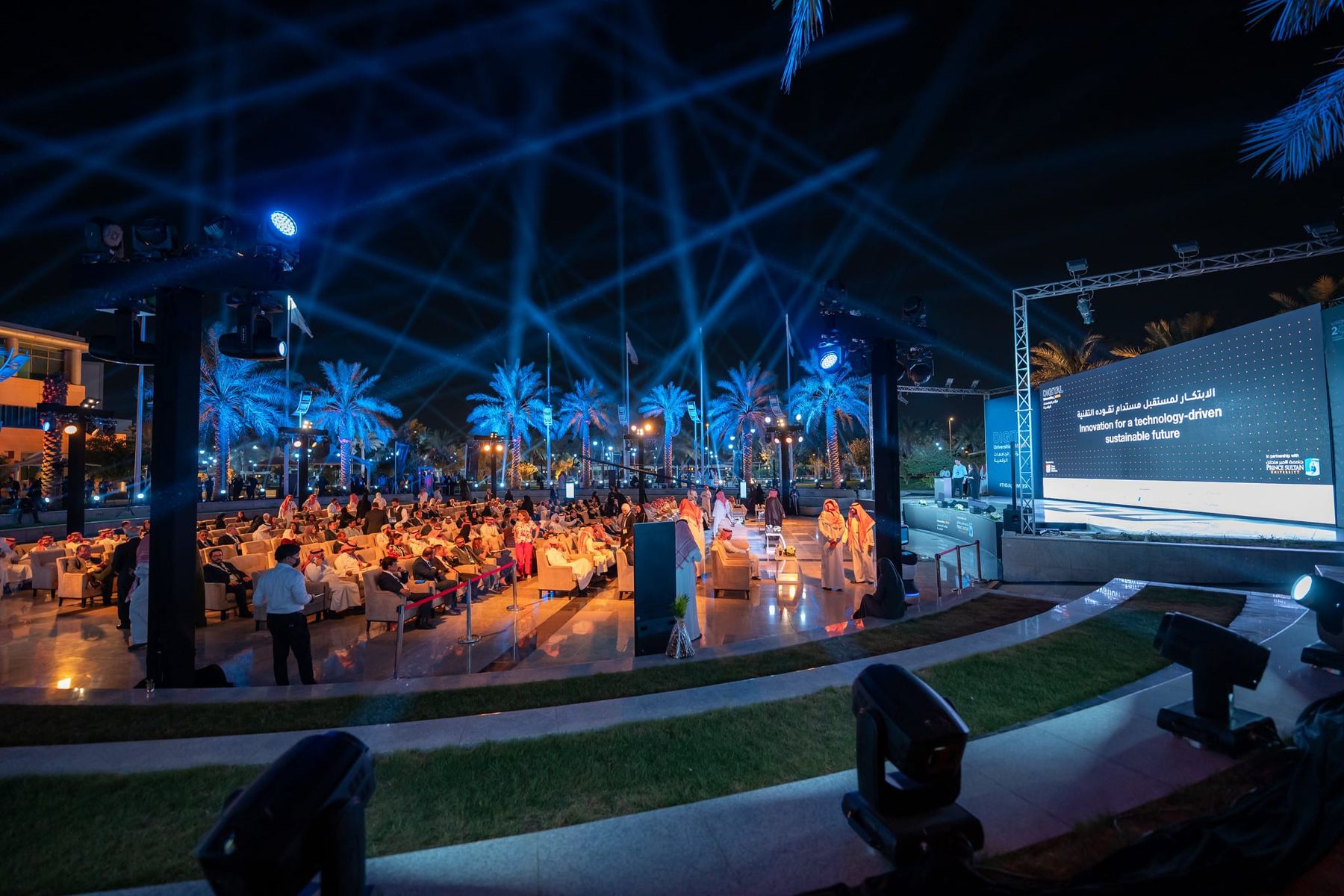 Outdoor conference stage lit at night in Riyadh