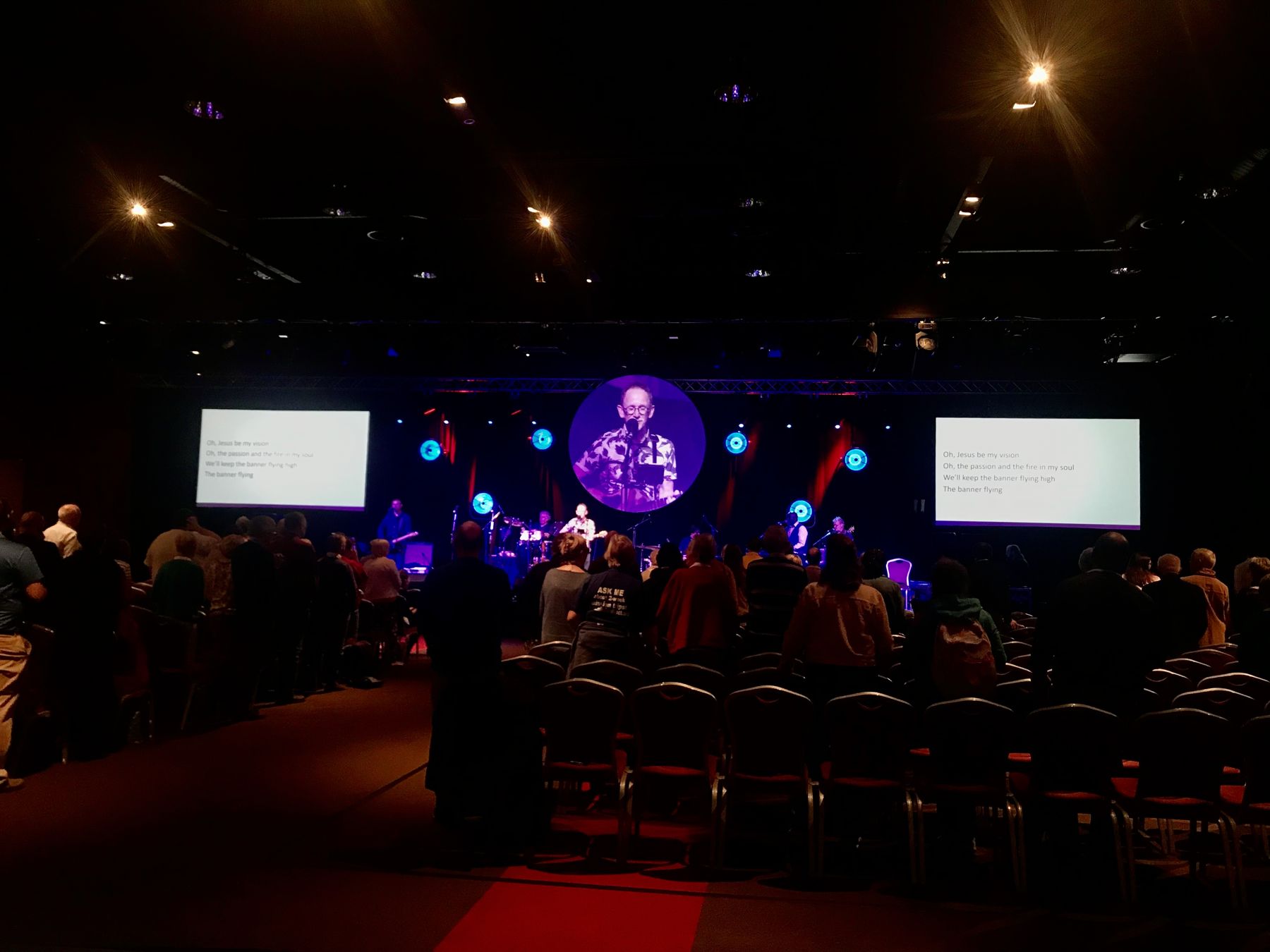 Worship band on stage in front of a church conference audience