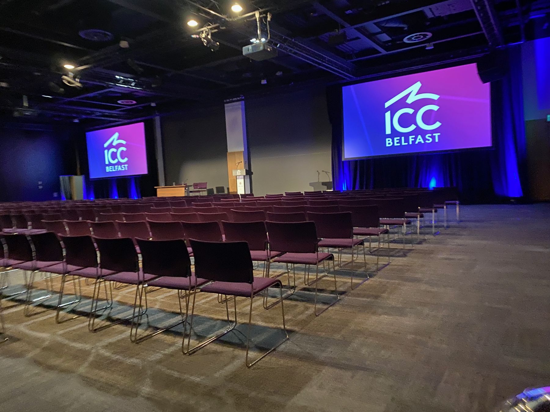 Conference hall at ICC Belfast set with screens and blue lighting